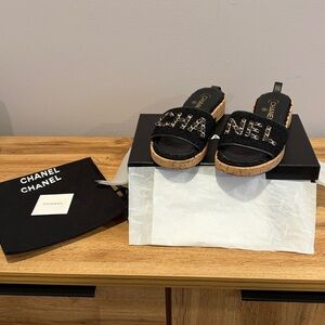 CHANEL Black and Tan Mules with Chain Detail